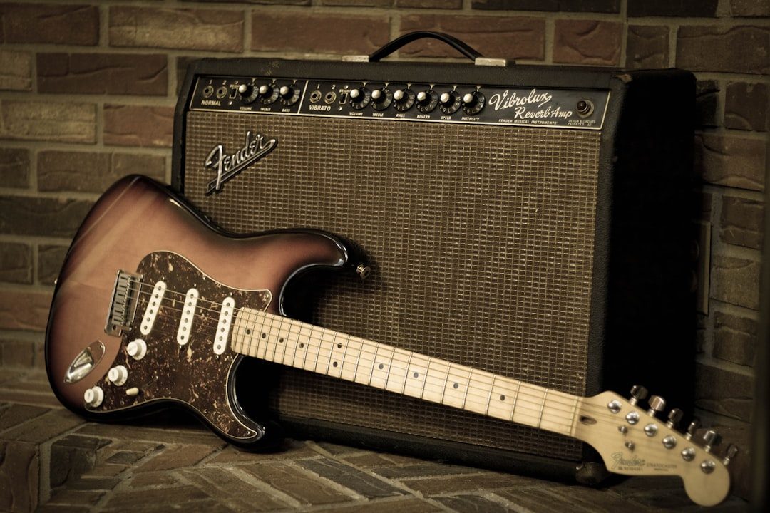 Electric guitar leaning against a vintage amplifier