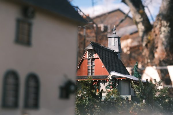 Small red and white building with a steeple.
