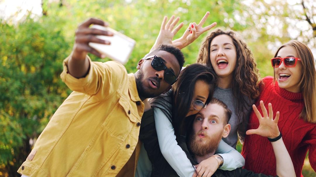 Diverse group of friends taking a selfie outdoors selfie